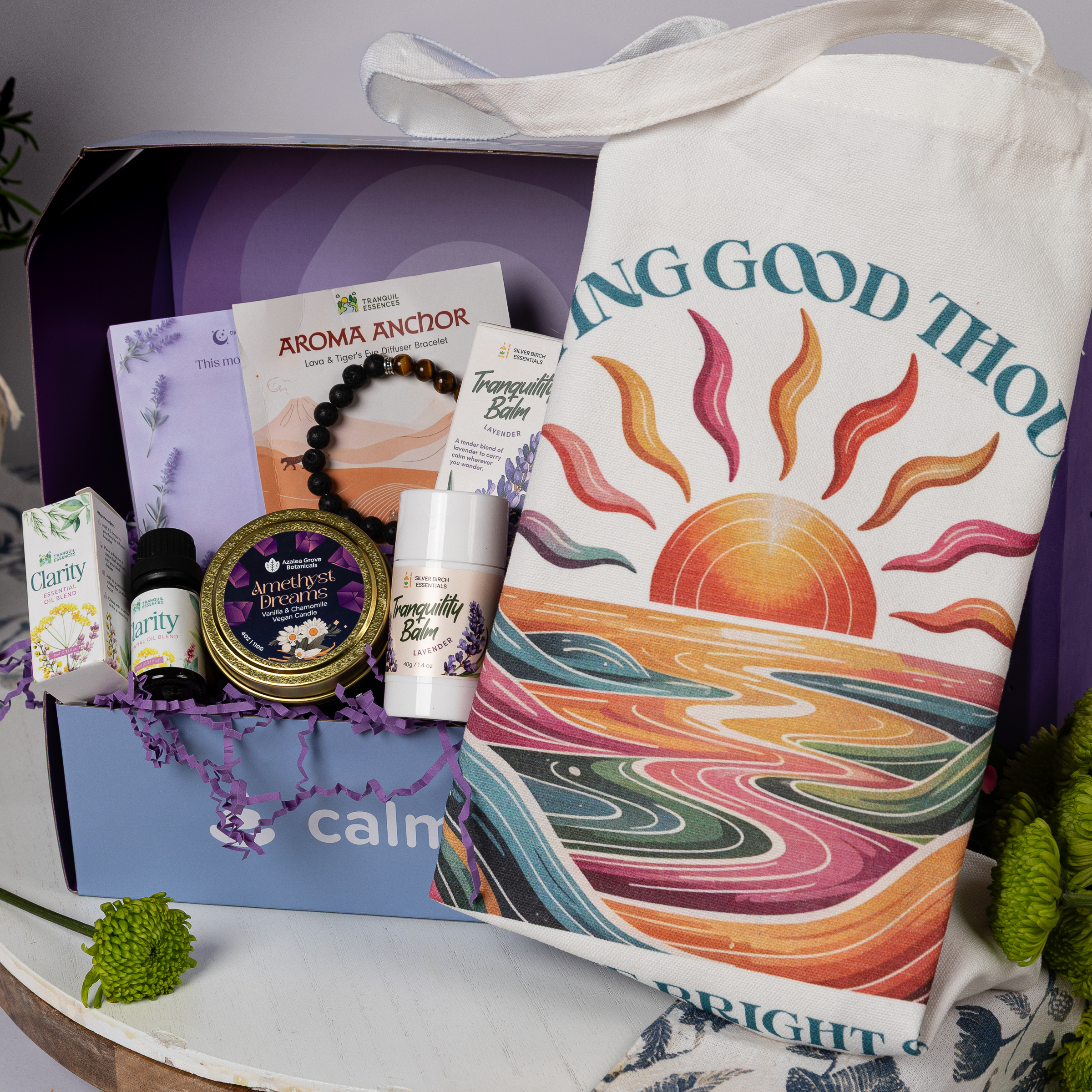 contents of the Woodland Peace calmbox - a candle, tote bag, bracelet, balm, and fidget cube