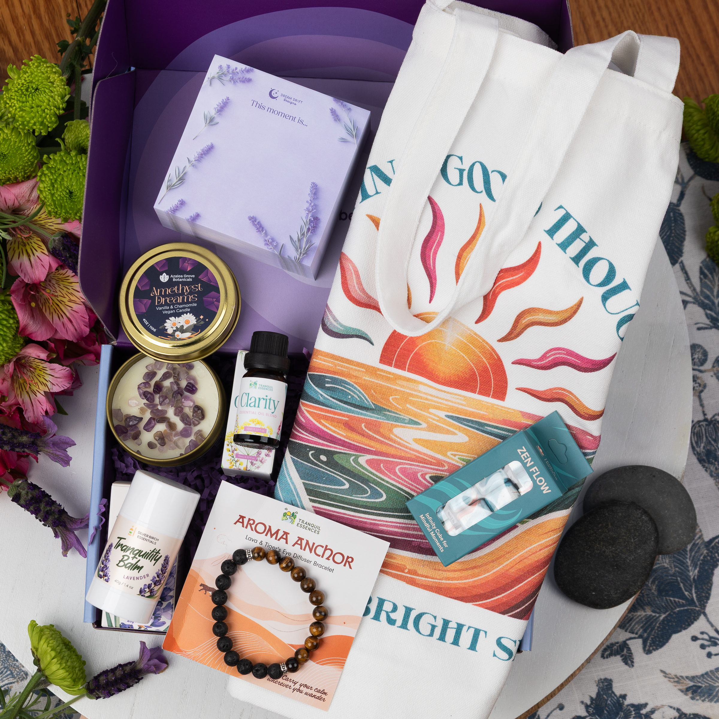 contents of the Woodland Peace calmbox - a candle, tote bag, bracelet, balm, and fidget cube